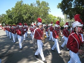 High school marching band performing in a parade